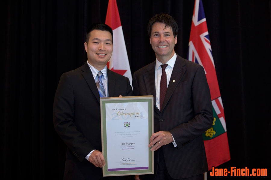 Paul Nguyen receives the Newcomer Champion Award from Hon. Eric Hoskins, Ontario Minister of Citizenship and Immigration