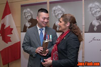 Minister Laura Albanese presents the June Callwood Award to Paul Nguyen